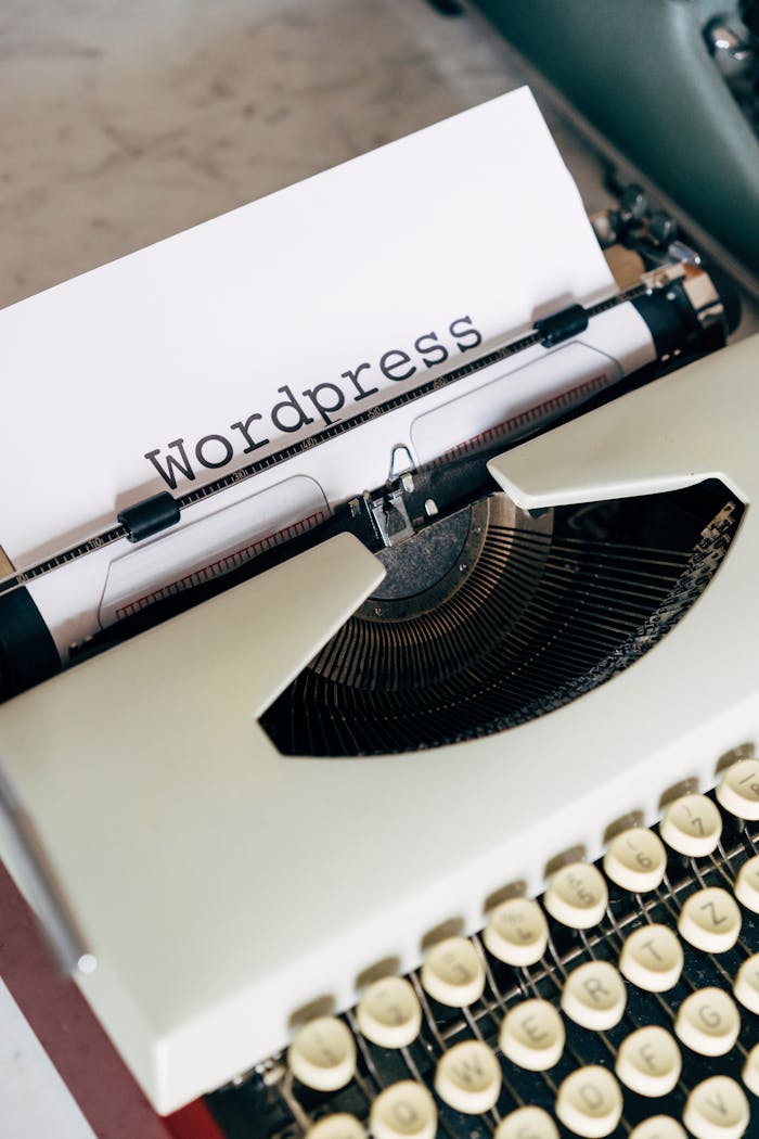 Close-up of a vintage typewriter with WordPress typed on paper, conveying a classic theme.
